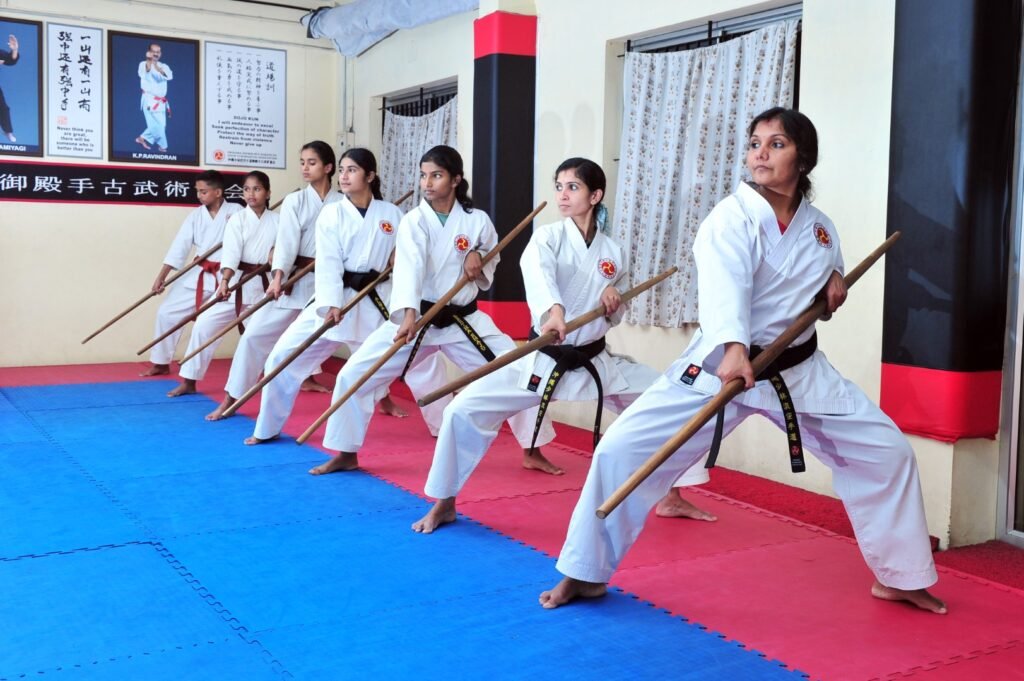 a diverse group of women empowered through the practice of traditional okinawan kobudo, training together with bo staffs. (large)